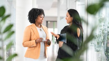 Two women in office talking