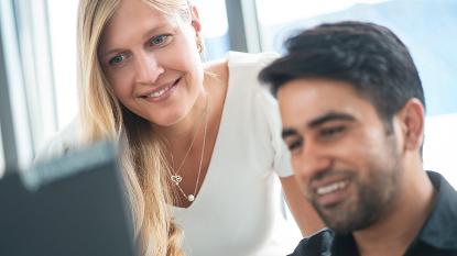 woman and man looking at monitor